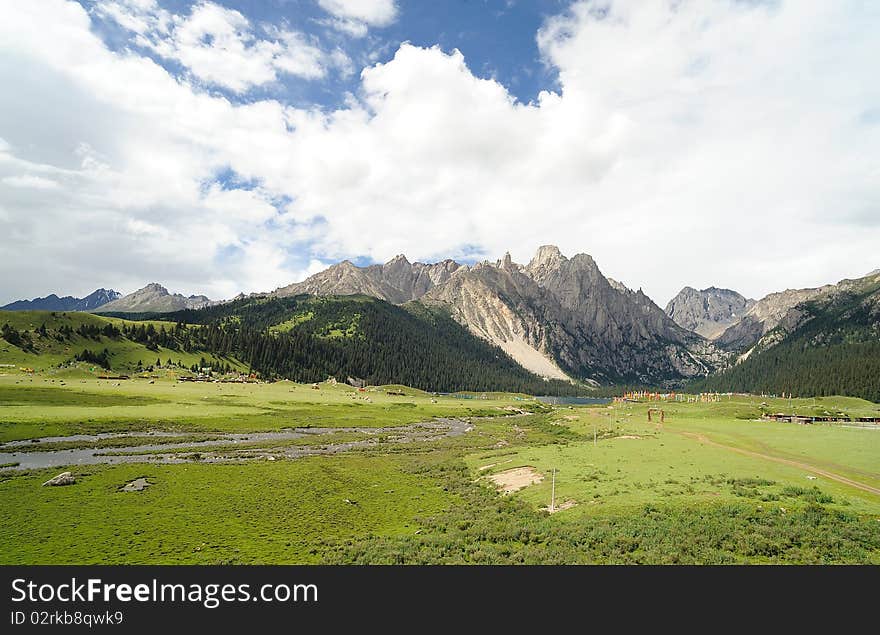 Blue sky, green grass, mountain and white clouds. Blue sky, green grass, mountain and white clouds