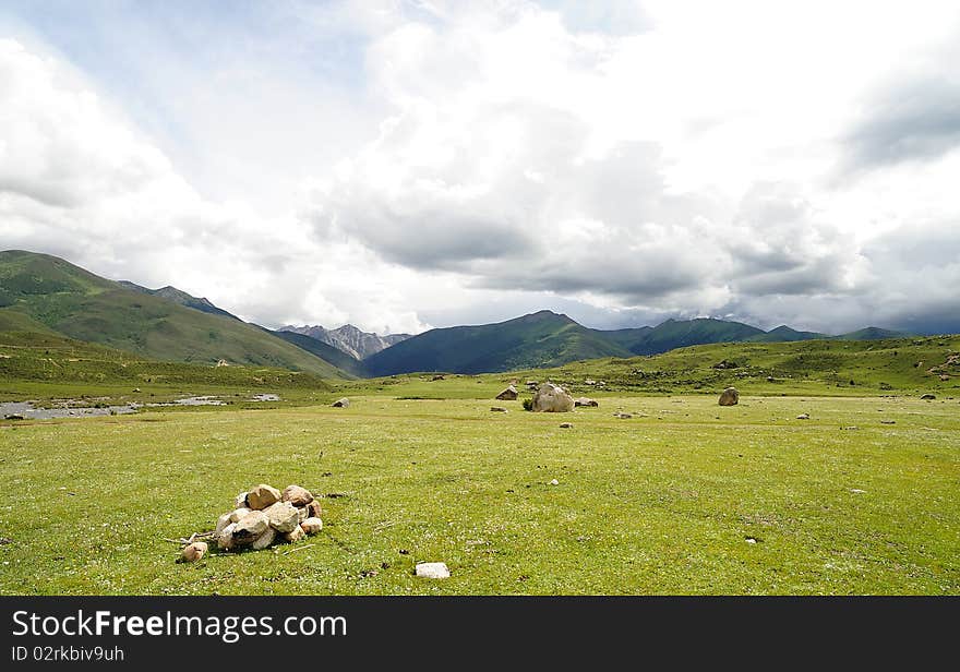 Blue sky, green grass, mountain and white clouds. Blue sky, green grass, mountain and white clouds