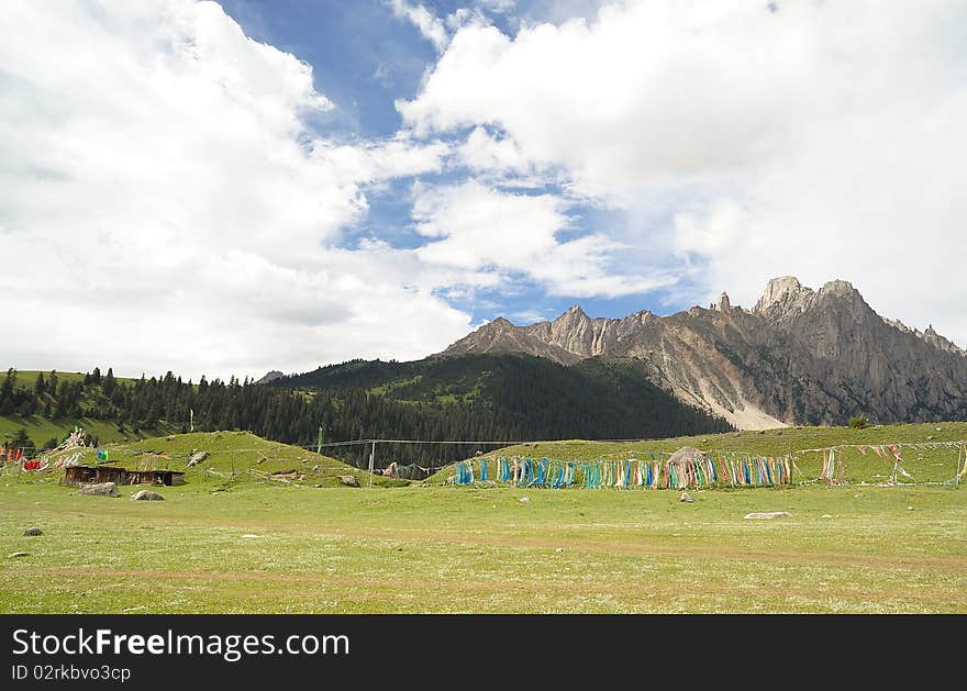 Blue sky, green grass, mountain and white clouds. Blue sky, green grass, mountain and white clouds