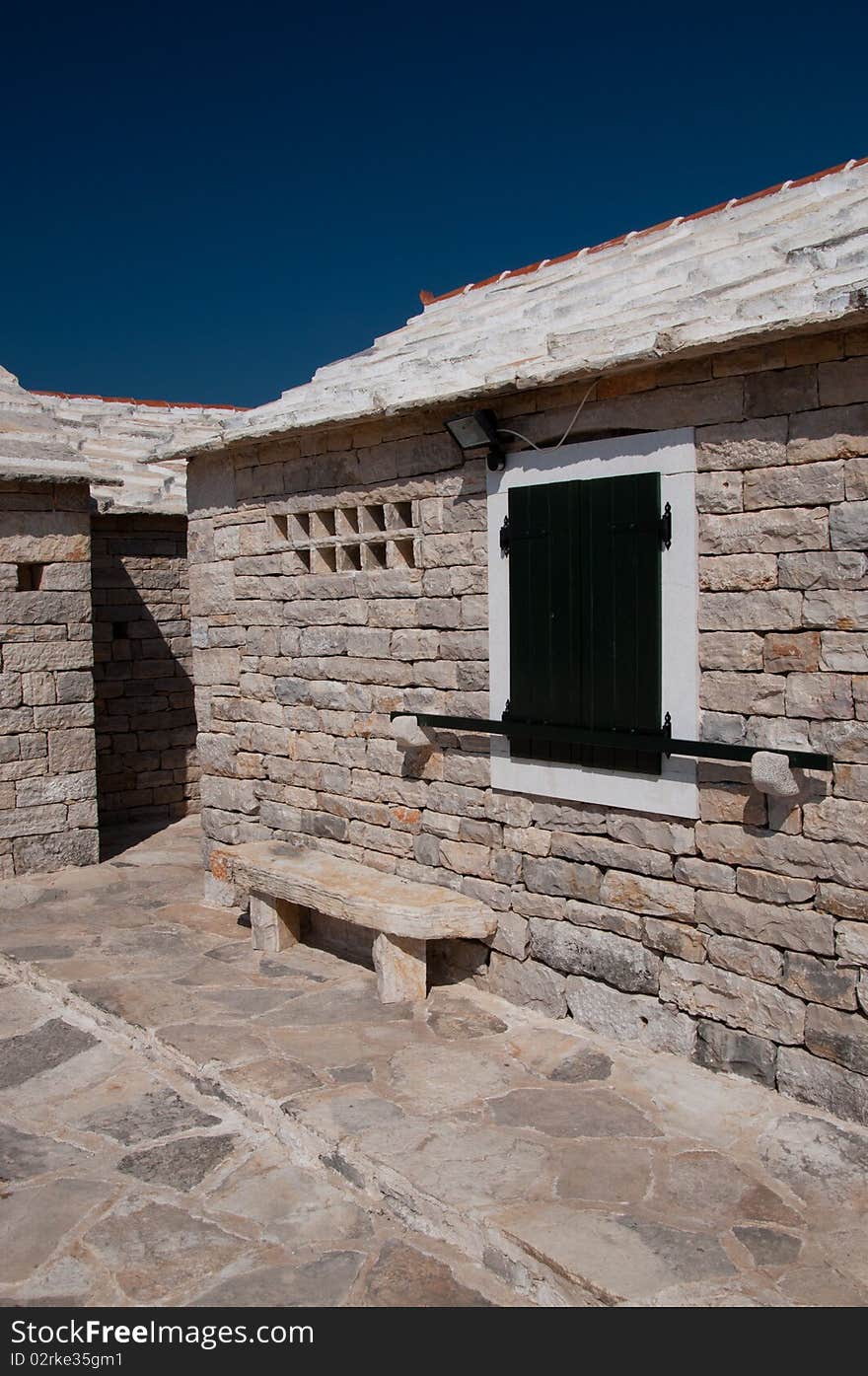 Croatian house made of white stone under the blue sky. Croatian house made of white stone under the blue sky.