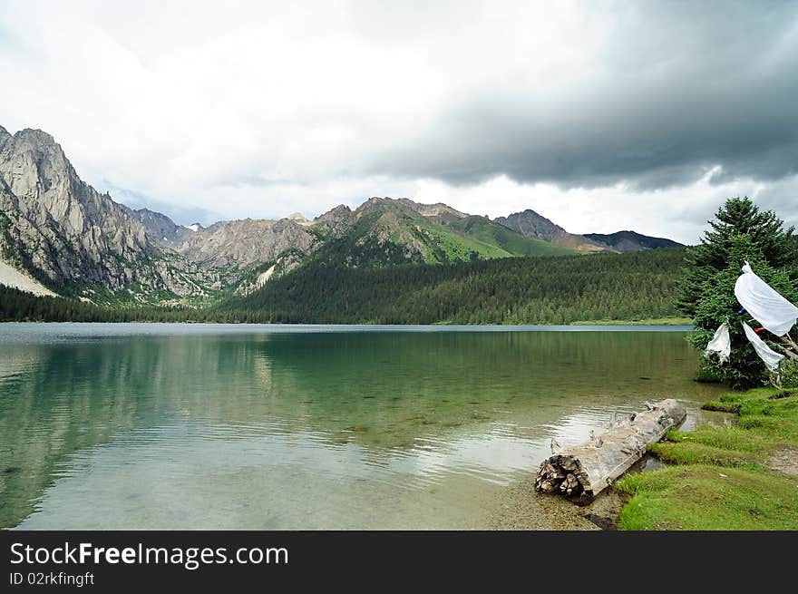 Highland lake, green grass, mountain and white clouds. Highland lake, green grass, mountain and white clouds