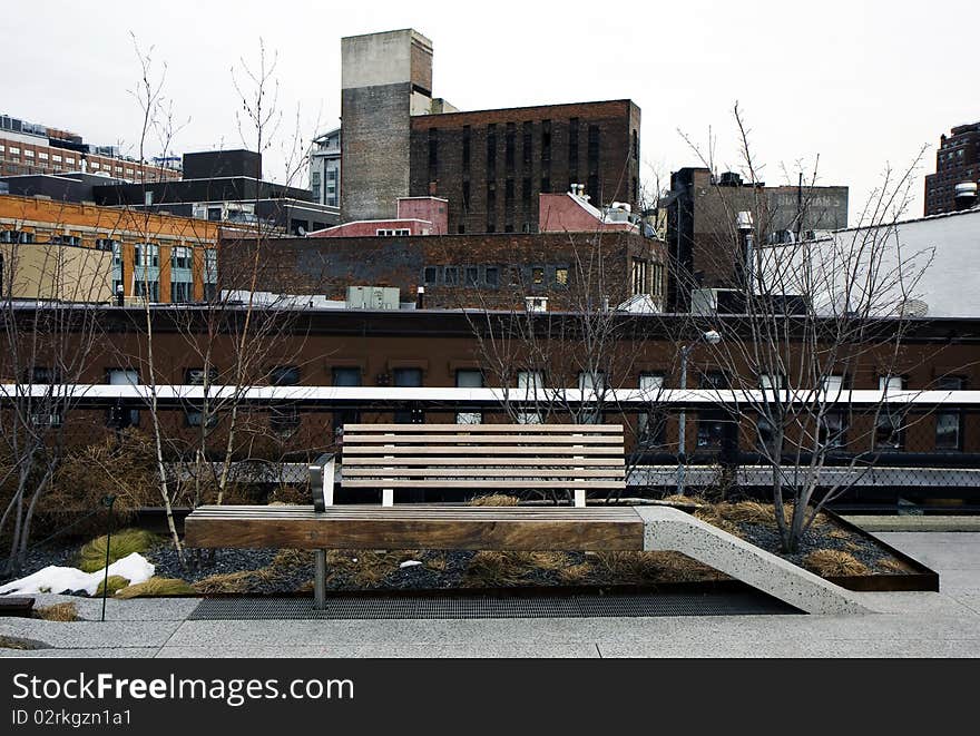 High Line park in Manhattan, New York with the city layers and a bench. High Line park in Manhattan, New York with the city layers and a bench