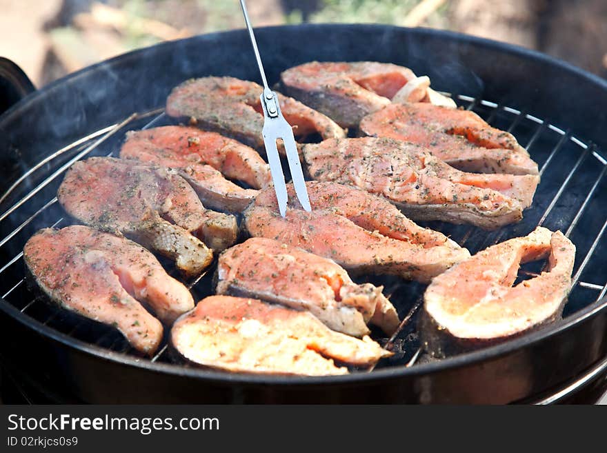 Fish salmon cooking on grill