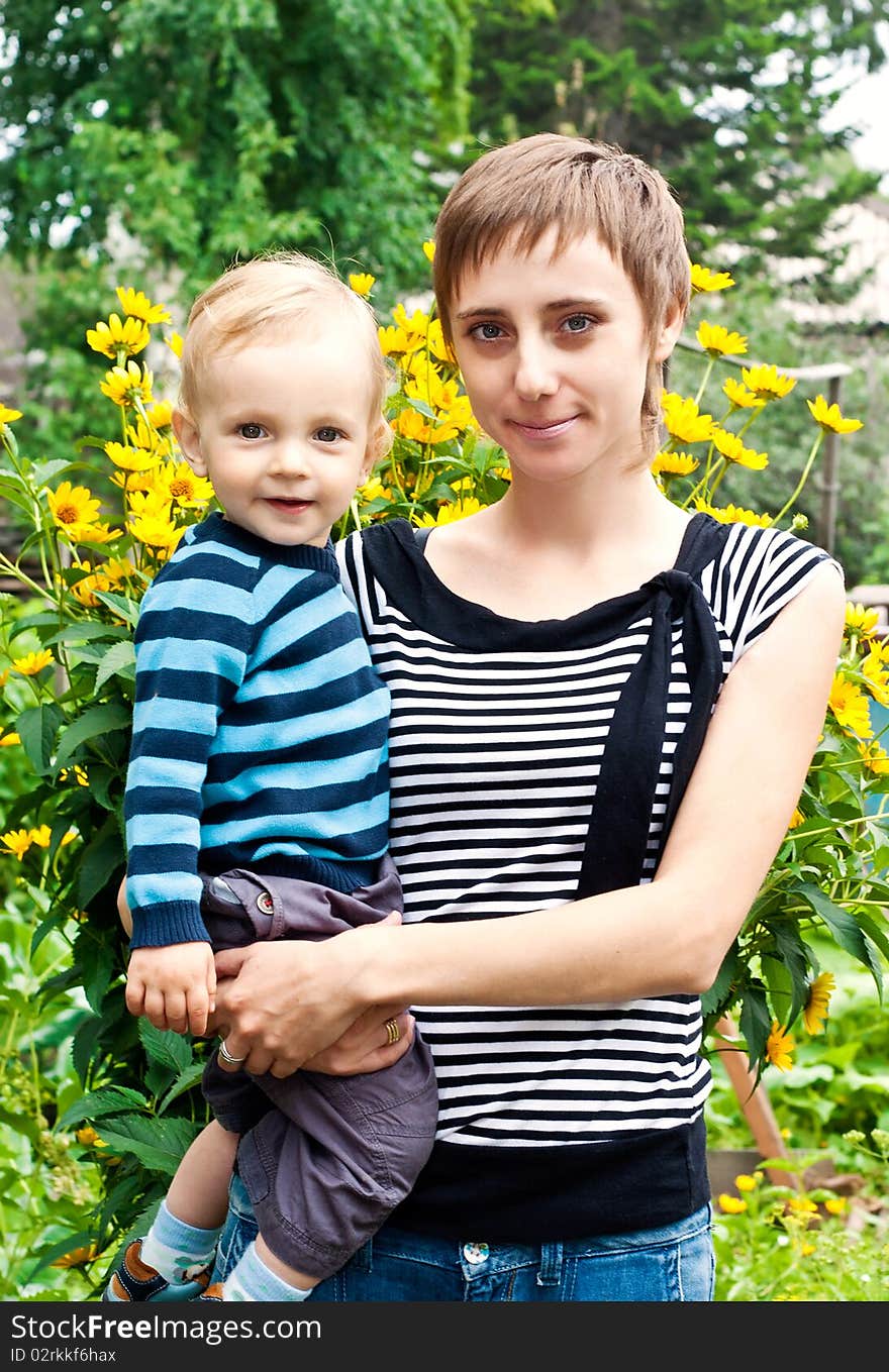 Young mother and son outdoors. Young mother and son outdoors