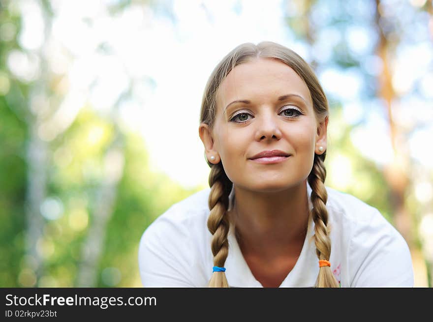 Young beautiful girl in a summer forest