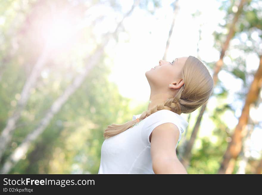 Young beautiful girl in a summer forest