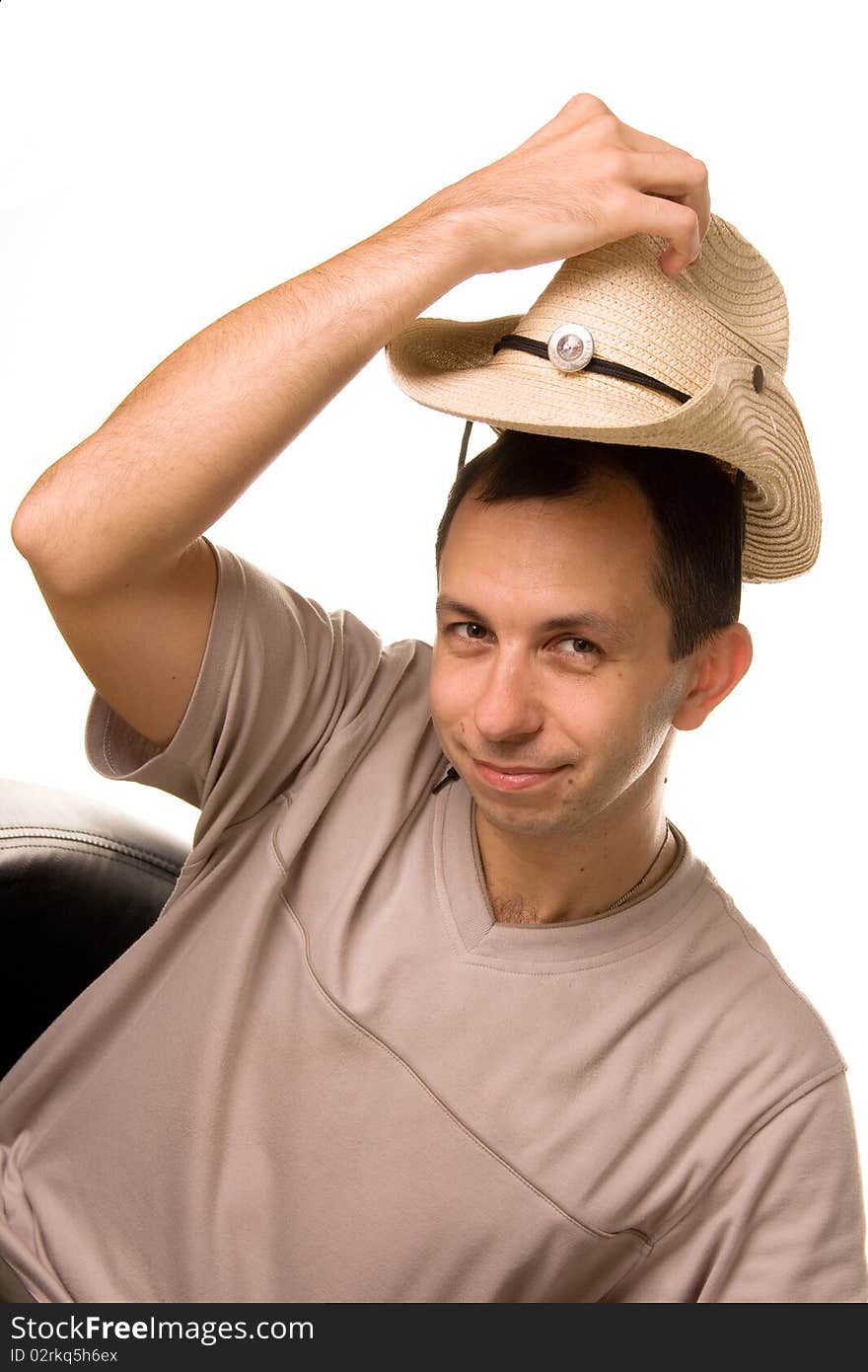 The man in a gray T-shirt puts on a straw hat a head. The man in a gray T-shirt puts on a straw hat a head