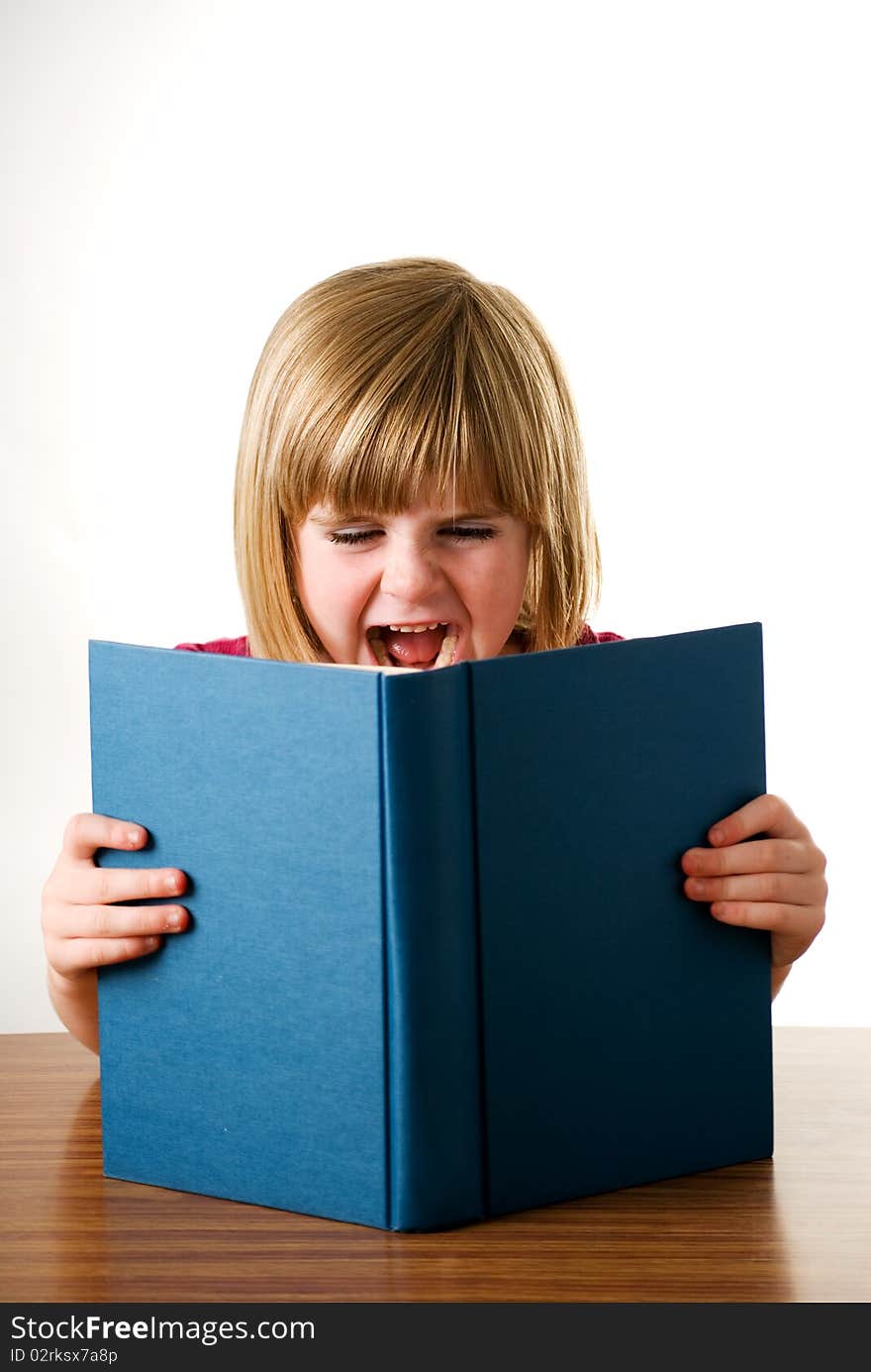 A vertical image of a pretty young girl shouting over her book isolated on a white background. A vertical image of a pretty young girl shouting over her book isolated on a white background