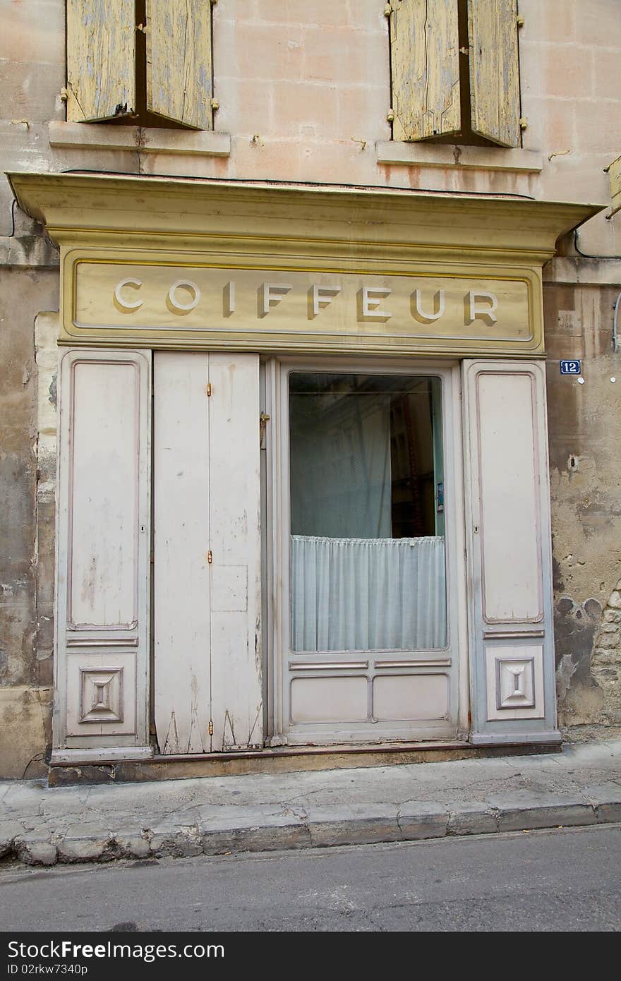 Old French coiffeur shop frontage on a road