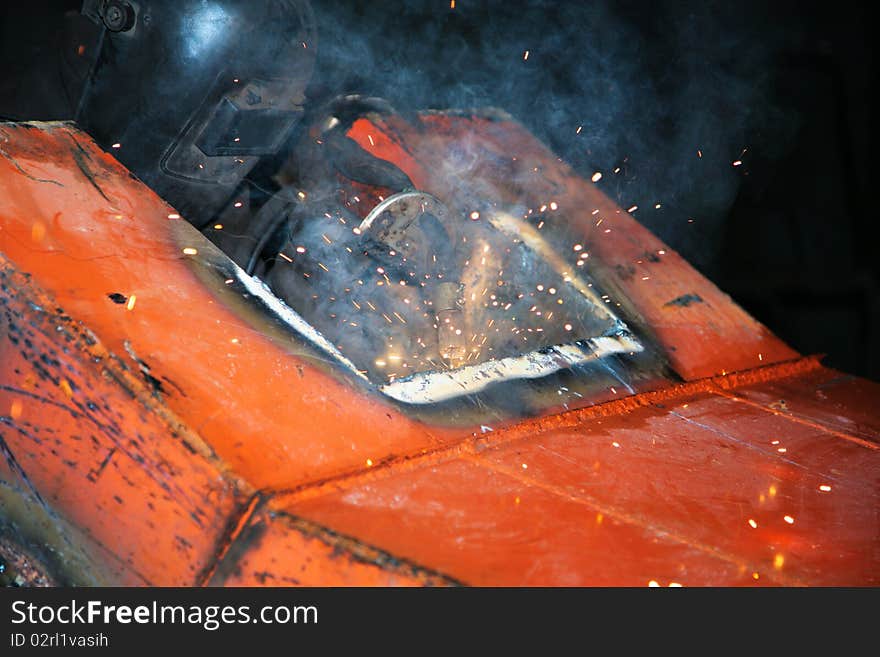 The welder behind work at a modern factory