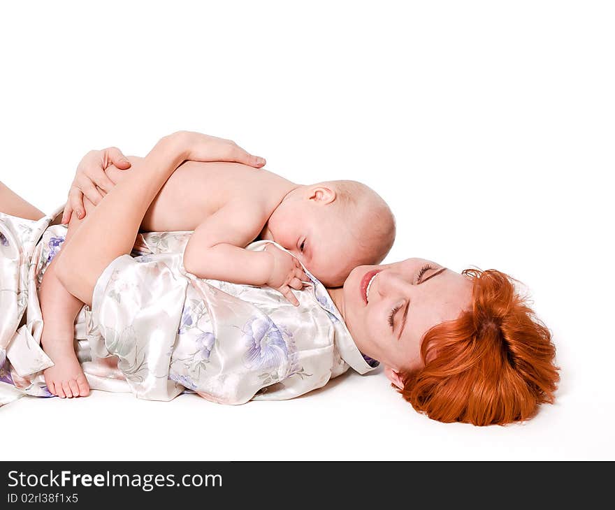 Cute 10 months baby boy lying on his mother. Isolated on white background