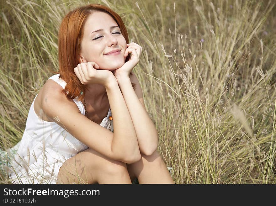 Beautiful Red-haired Girl At Grass