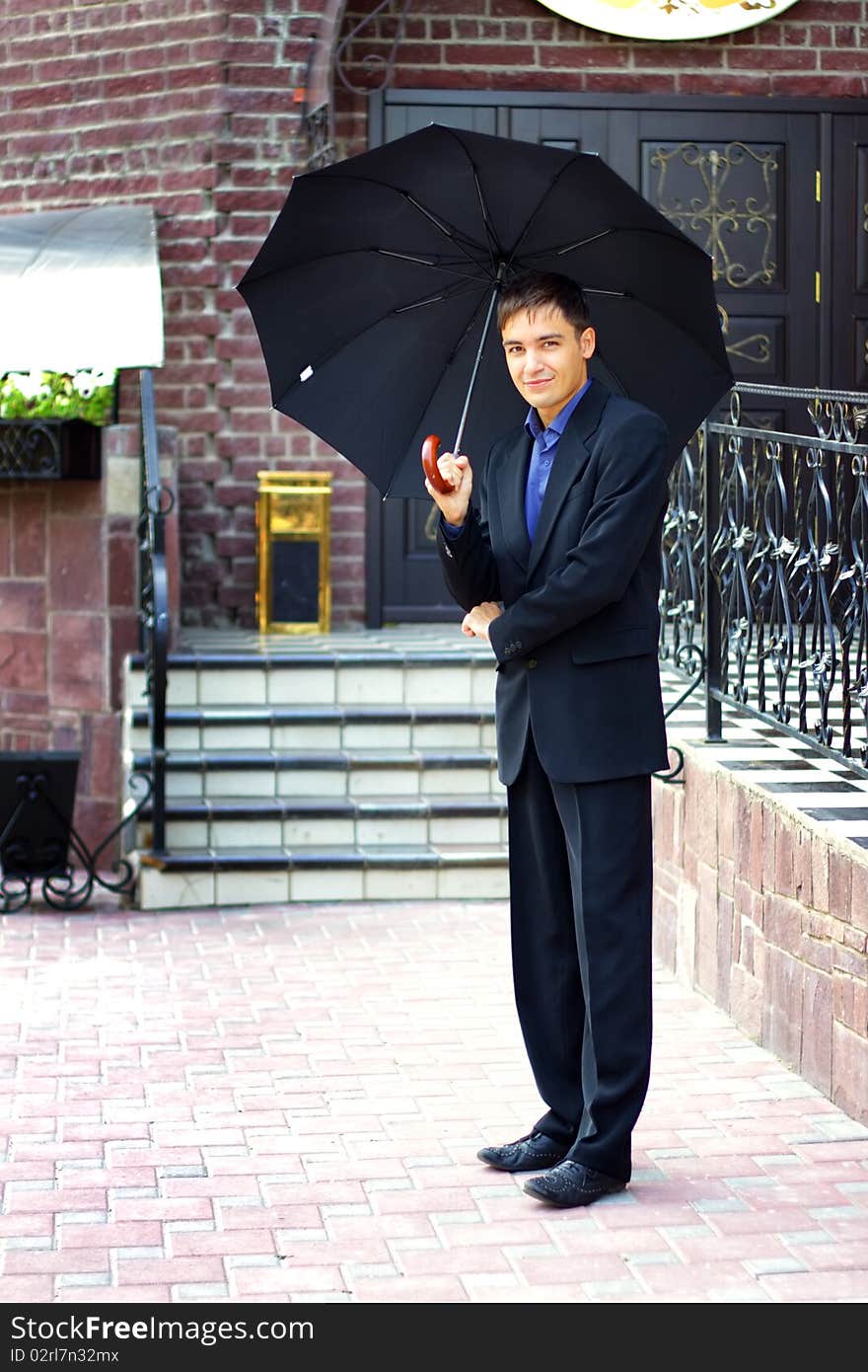 Man in black with an umbrella