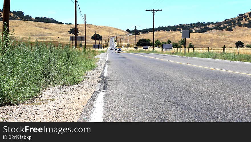 Countryside road through meadows and grass fields. Countryside road through meadows and grass fields