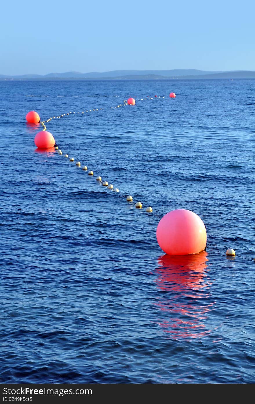 Several buoys marking a safe way for boats