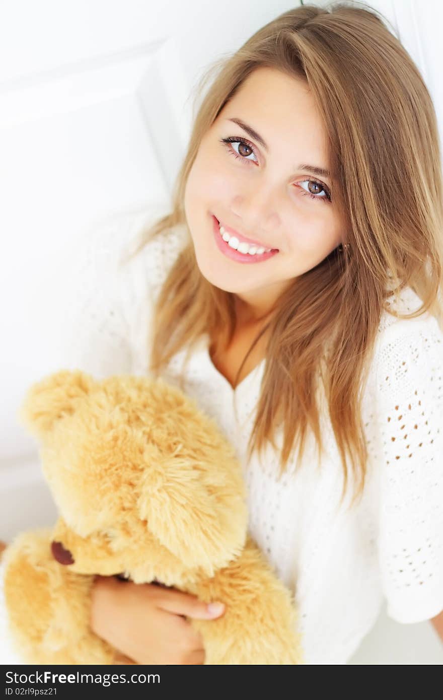 Girl hugs teddy bear