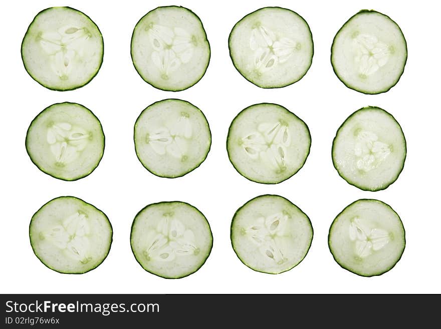 12 cucumber slices isolated on white background