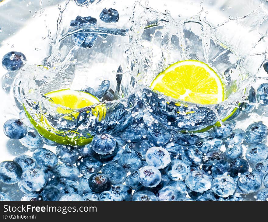 Fruits splashing the water in frozen motion