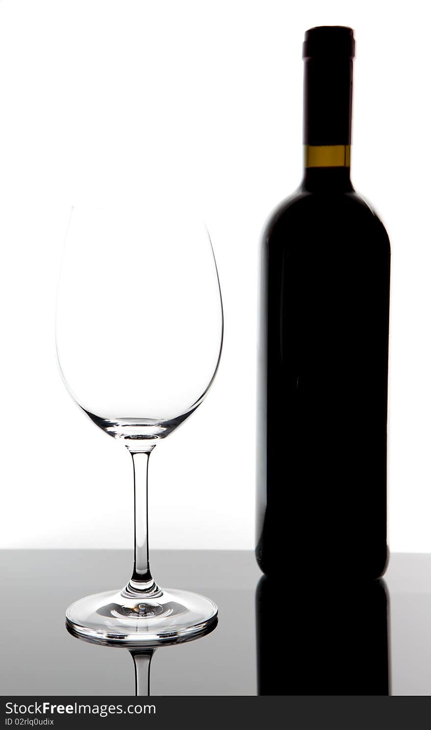 Red wine glass and bottle