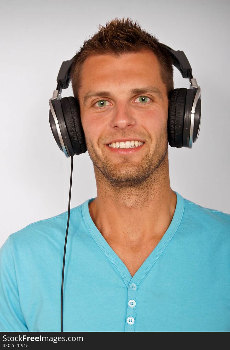 Portrait of young man with headphones, smiling happy