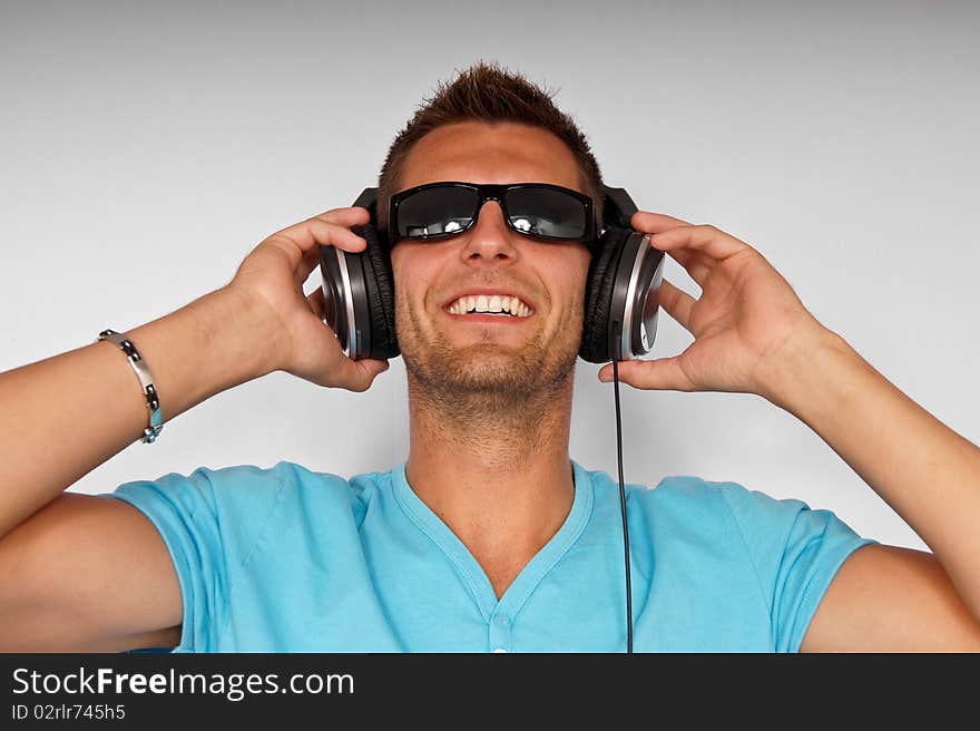 Young Man In Sunglasses With Headphones