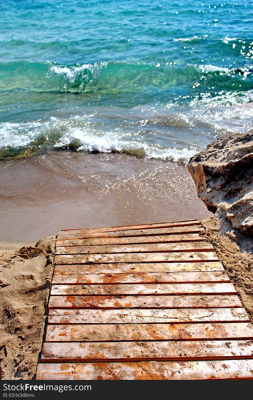 Waves on sandy beach in greek island