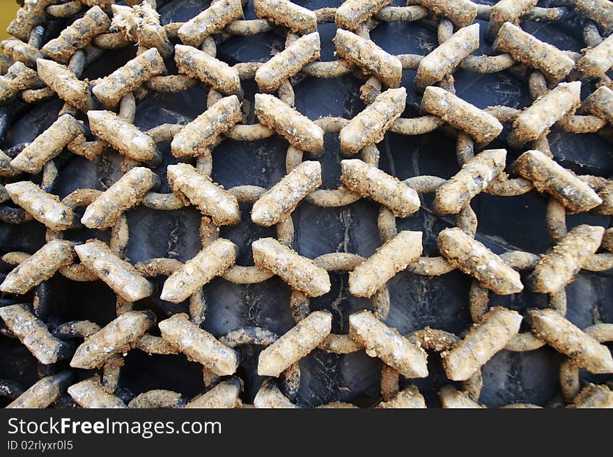 Closeup to dirty tire chain of a loader