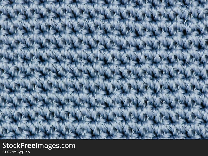 Blue knitted texture for backgrounds. Blue knitted texture for backgrounds.