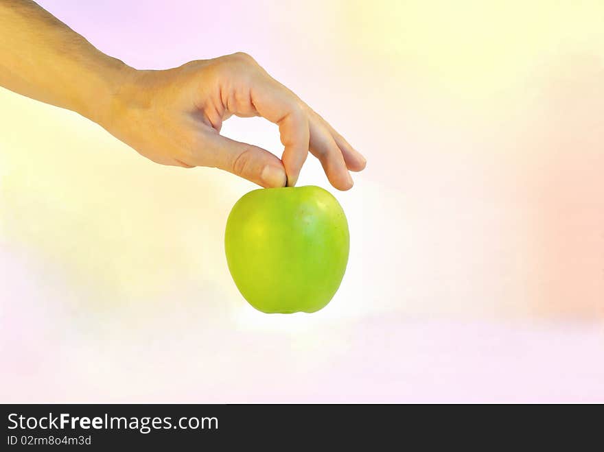 A green apple is against colour backgrou