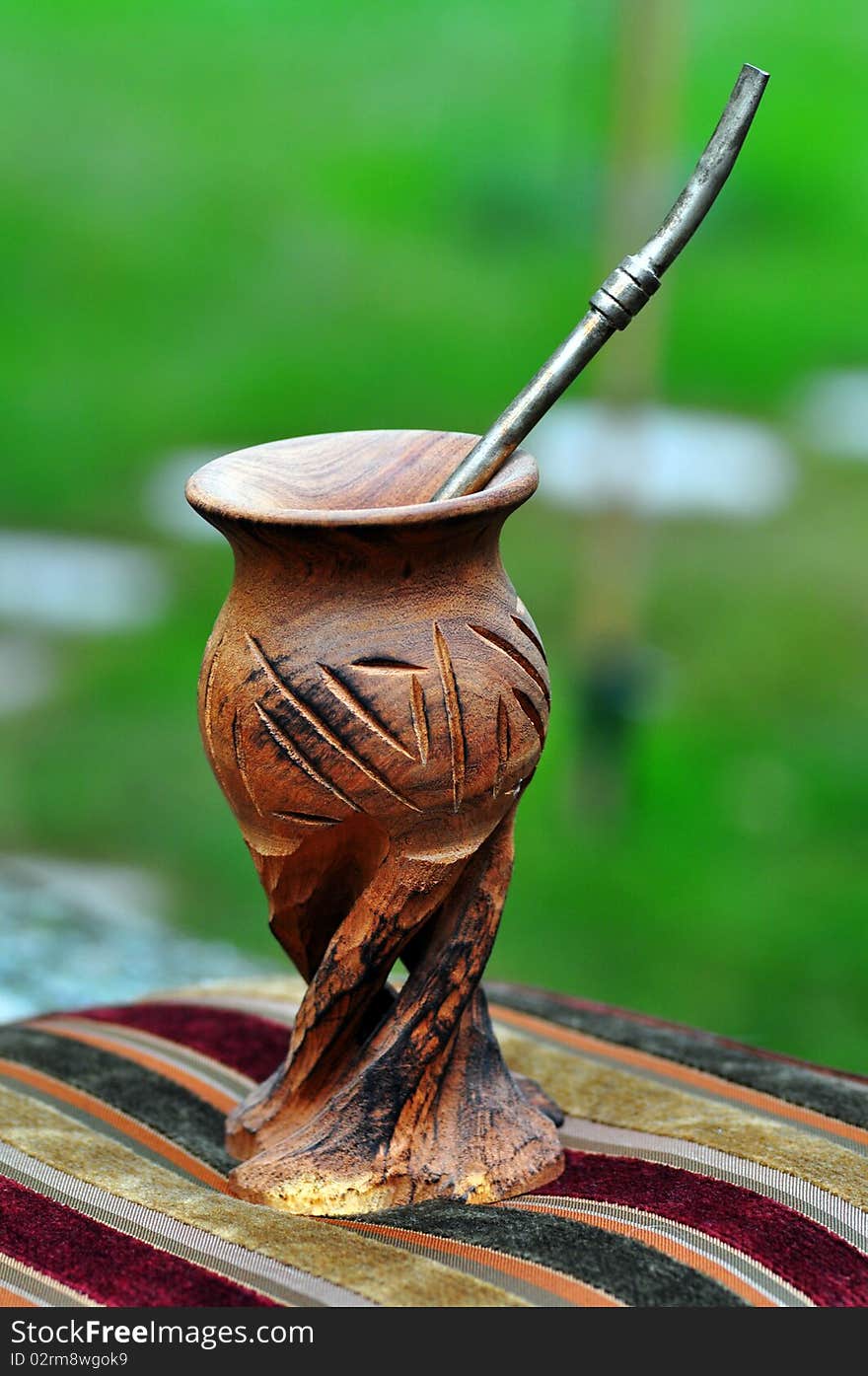 A calabash with a bombilla in it. A calabash with a bombilla in it