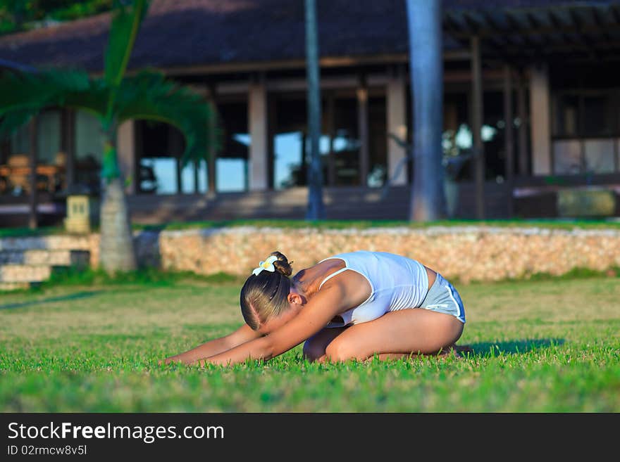 Young woman doing yoga exercise outdoors