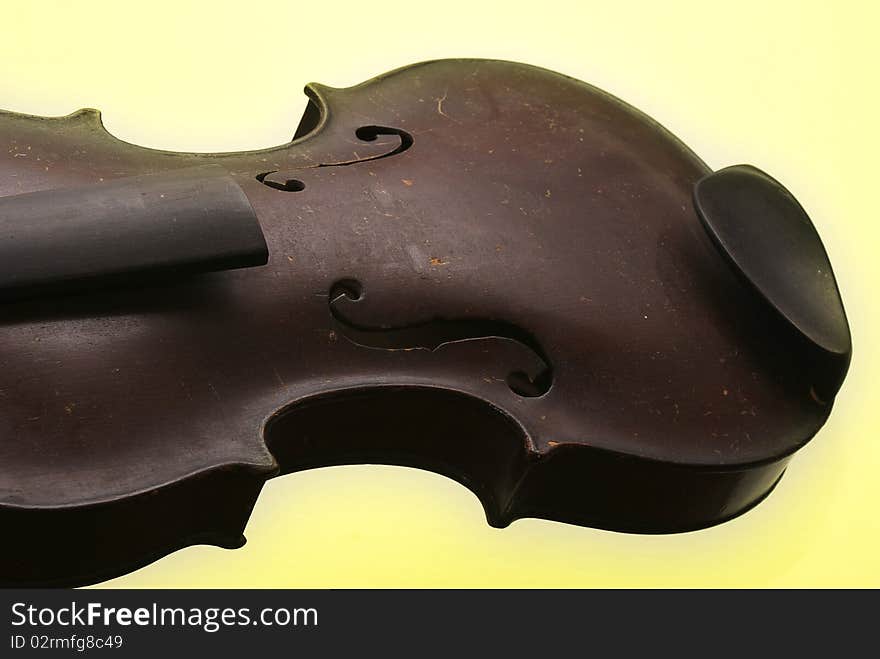 Old broken violin on a colored background. Old broken violin on a colored background