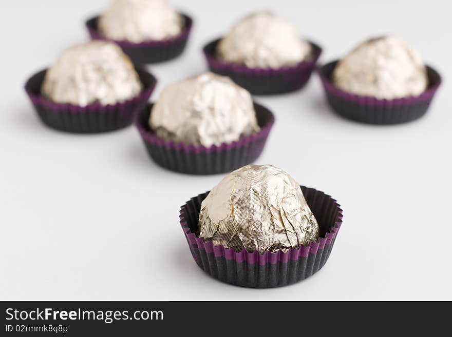 Choco  Candies In Golden Foil On Table