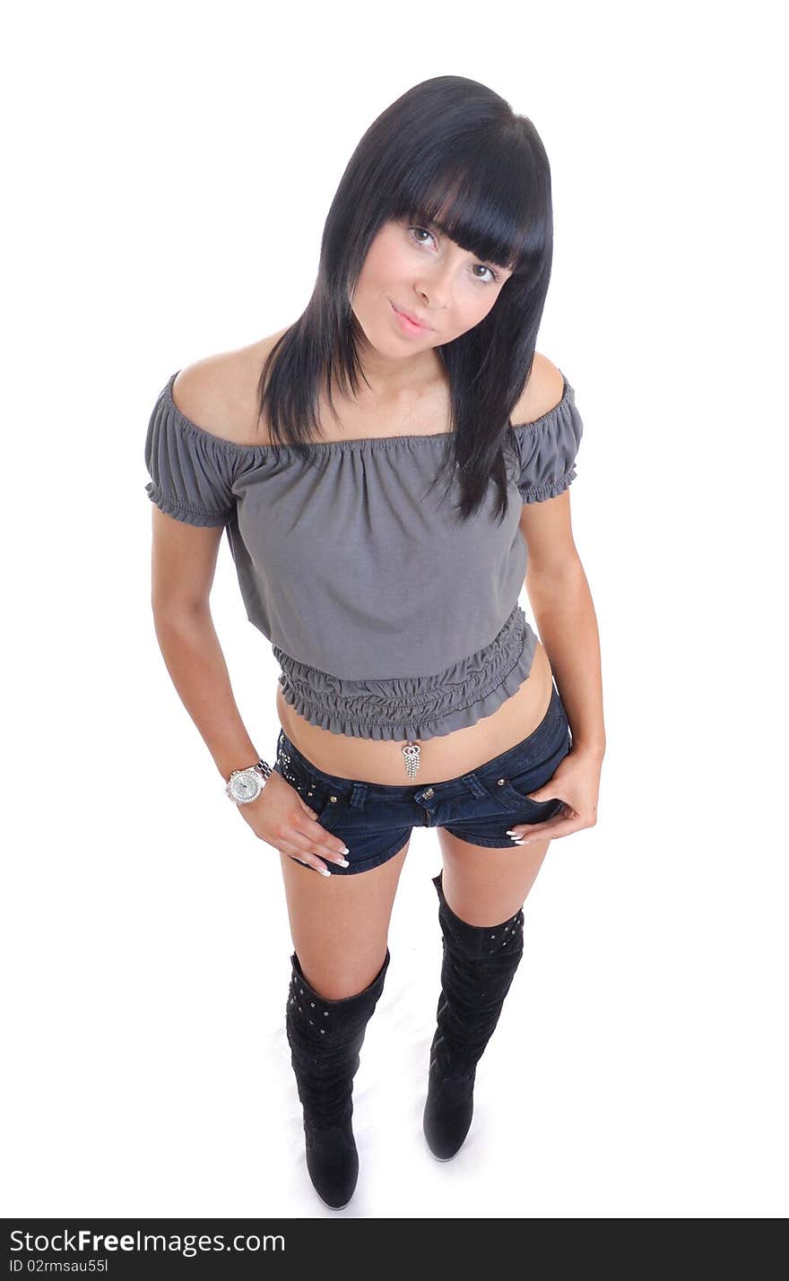 Cute young girl isolated against white in shorts and boots