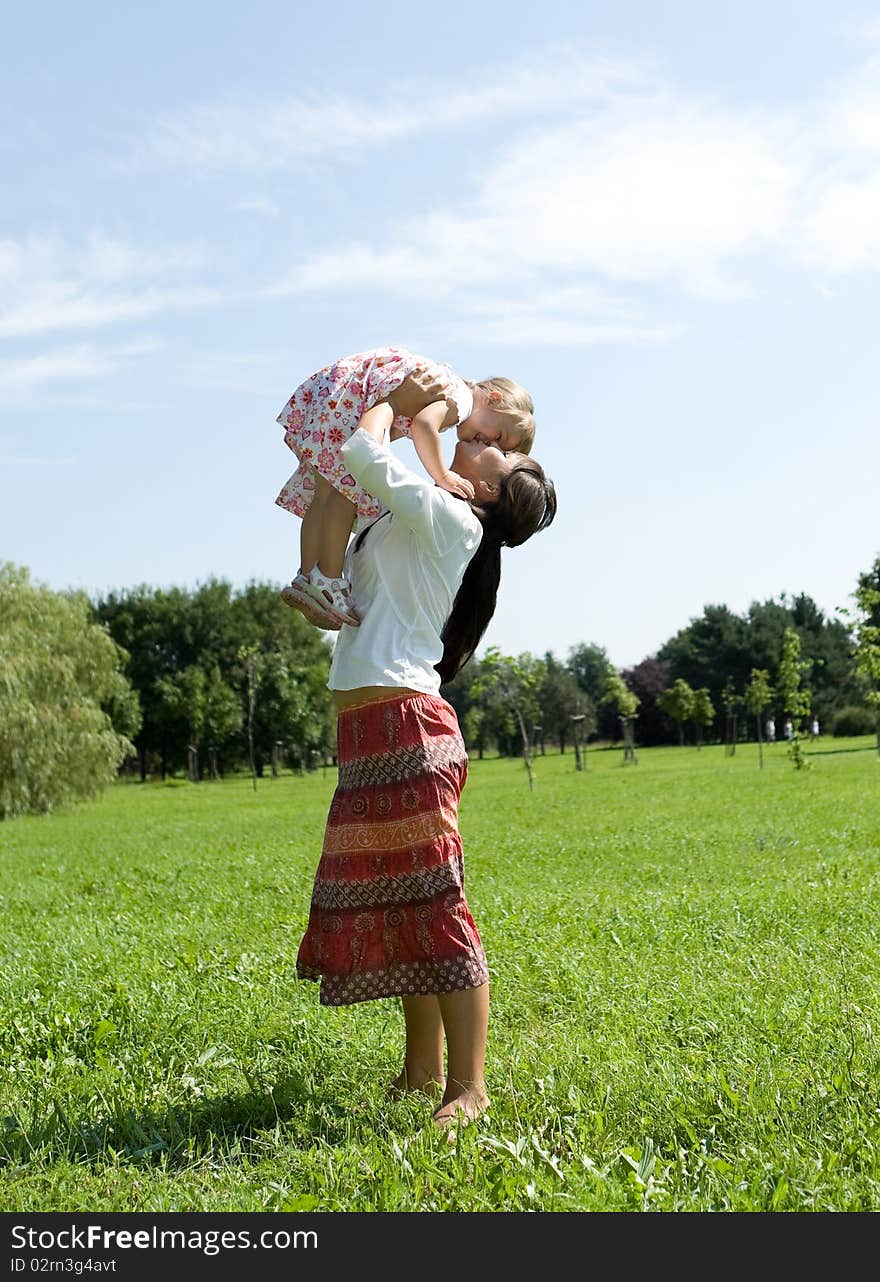 Mother and daughter having fun on meadow. Mother and daughter having fun on meadow