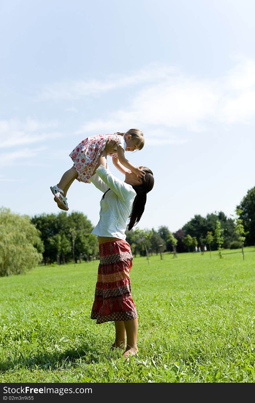 Mother and daughter having fun on meadow. Mother and daughter having fun on meadow