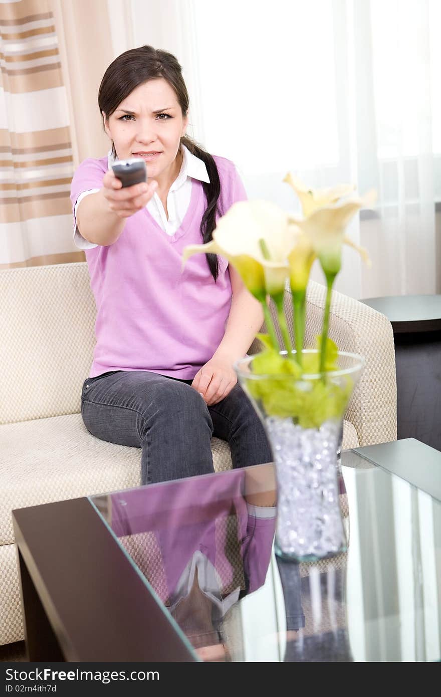 Young adult woman watching tv at home