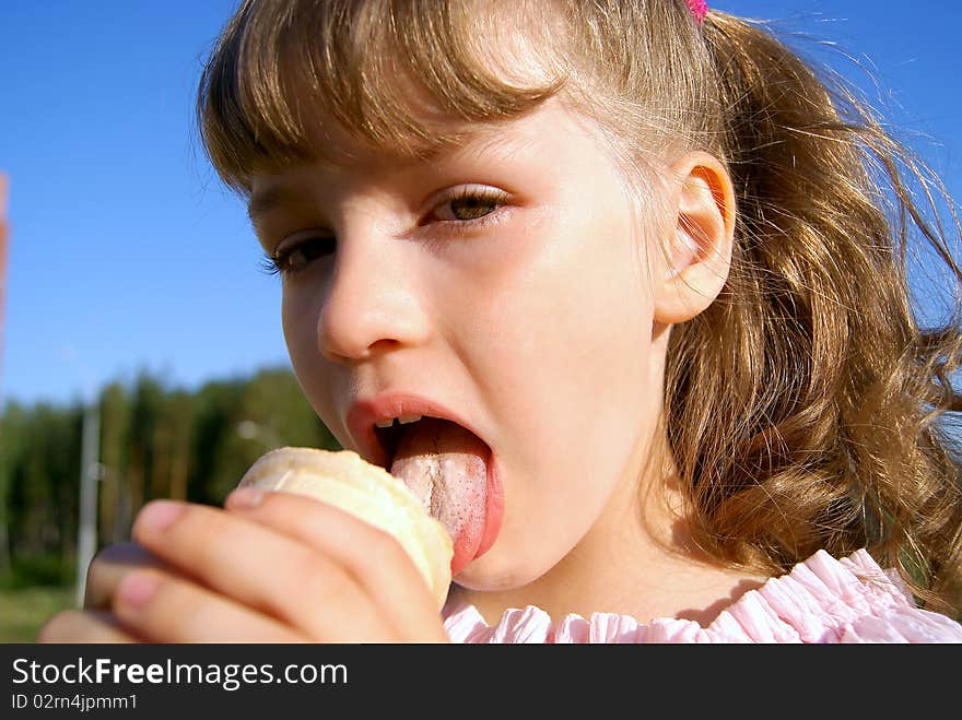 In the summer in park the girl eats ice-cream. In the summer in park the girl eats ice-cream