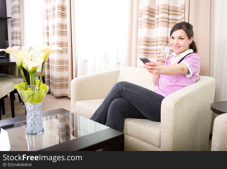 Young adult woman watching tv at home