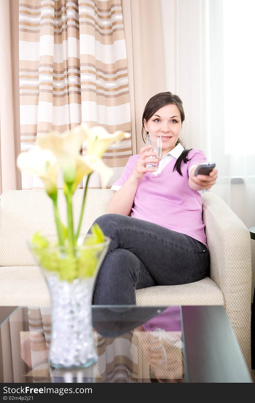 Young adult woman watching tv at home