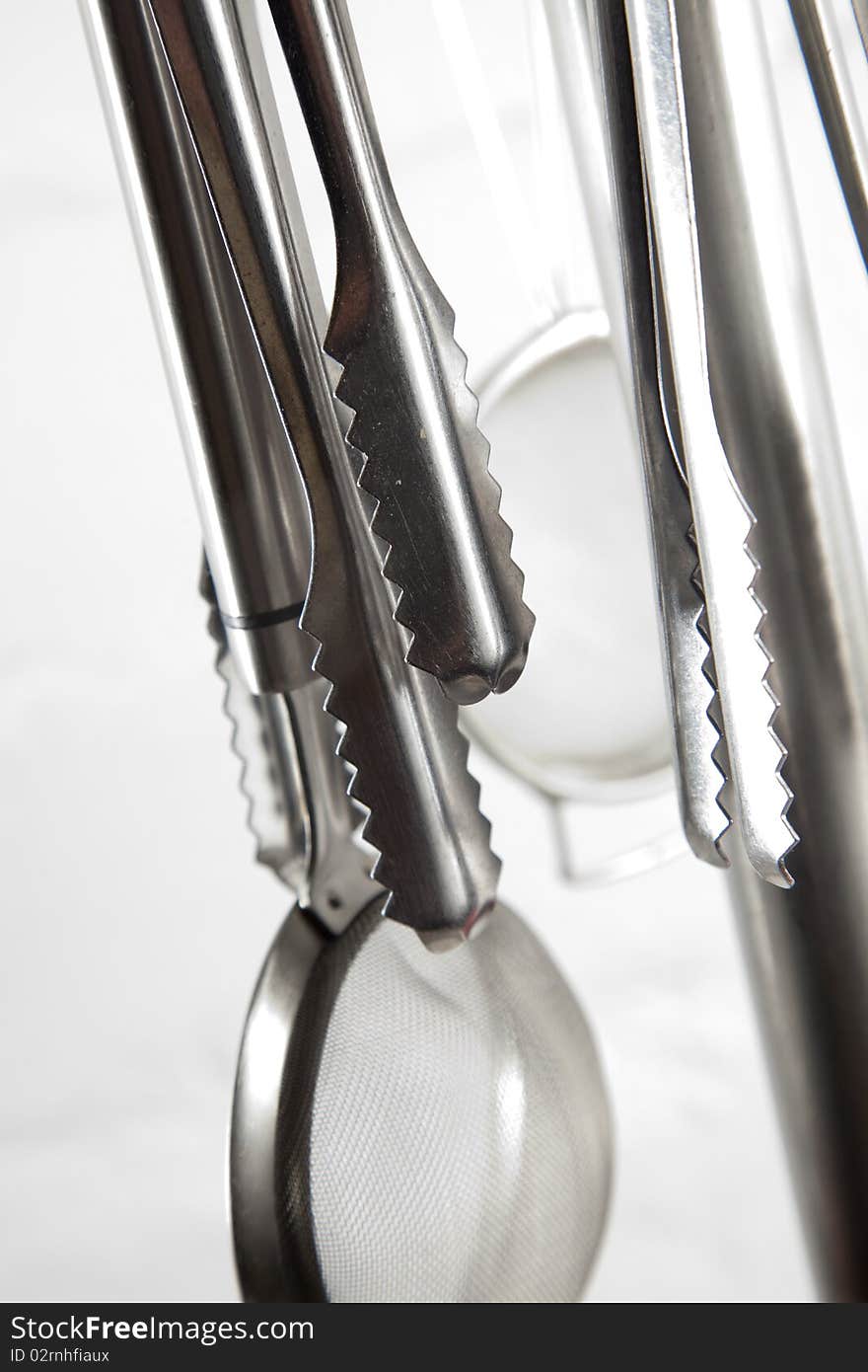 Kitchen utensils hangin in kitchen on a white background. Kitchen utensils hangin in kitchen on a white background.