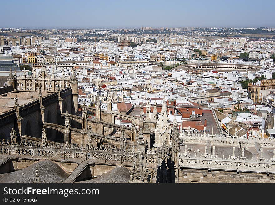 City overview of Seville, Spain.
In the background: Plaza del Toros, in the foreground: Giralda Cathedral.