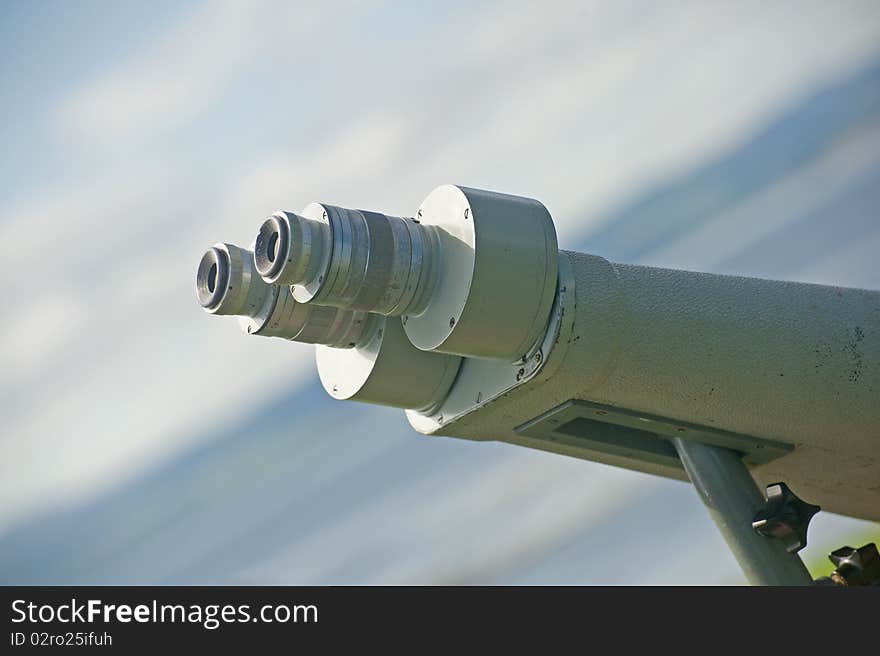 A closeup image of a binocular telescope in a fixed position for bird and Dolphin watchers. A closeup image of a binocular telescope in a fixed position for bird and Dolphin watchers.