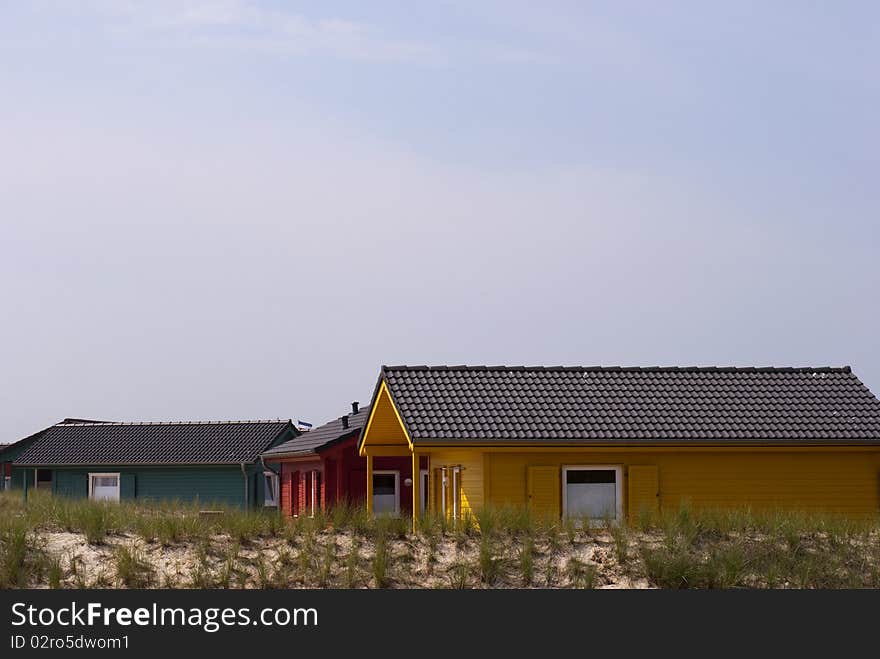 Green, red and yellow countryside houses on Dune island close to Helgoland, Germany.