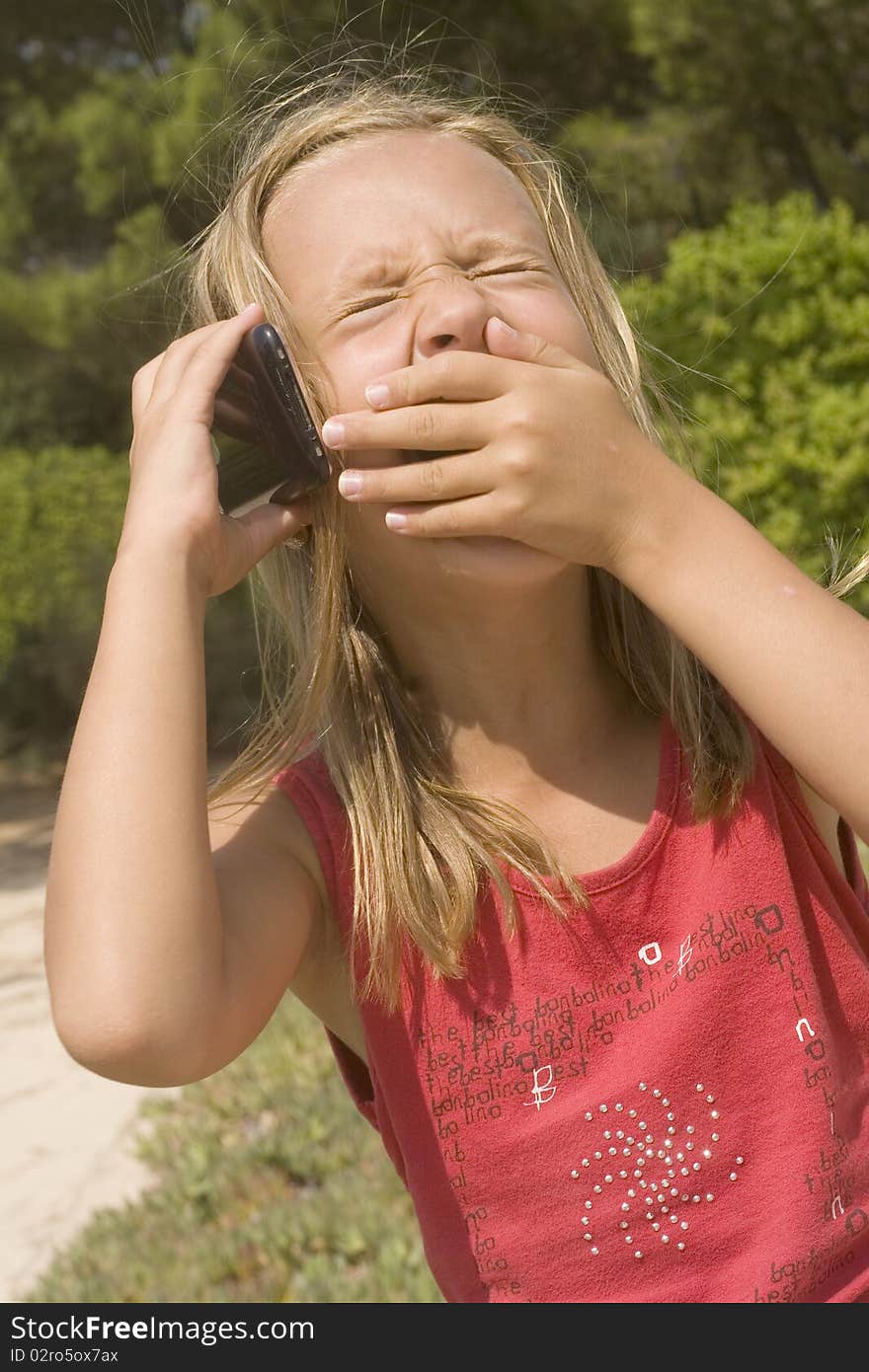 Child hold the mobile phone and smile. Child hold the mobile phone and smile