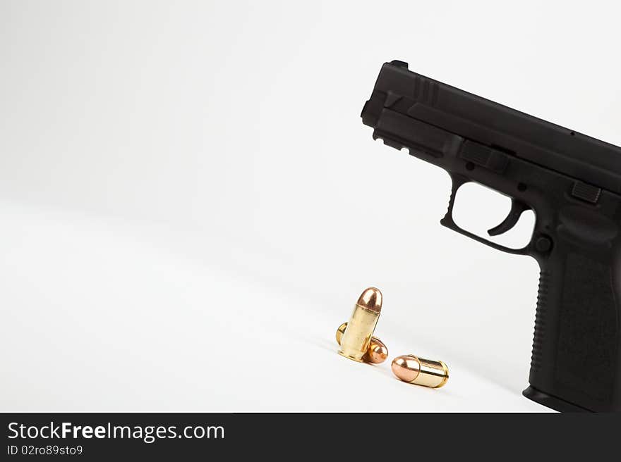 Gun and ammunition on an angle against a white background. Gun and ammunition on an angle against a white background