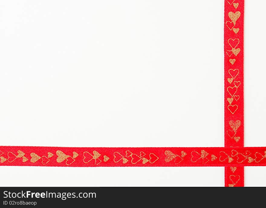 Red ribbon decorated with hearts against white background. Red ribbon decorated with hearts against white background