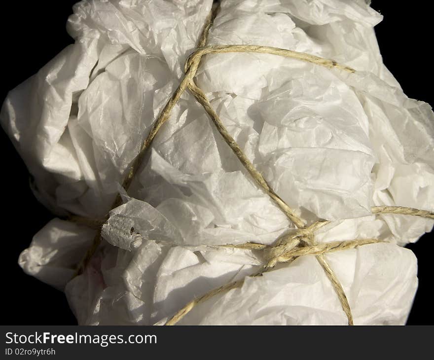 Untidy parcel of tissue paper tied with string