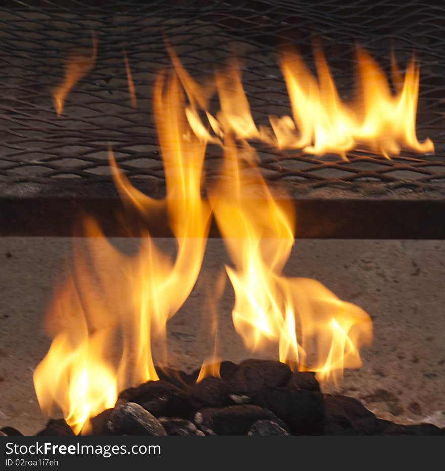 Flames on charcoal barbecue