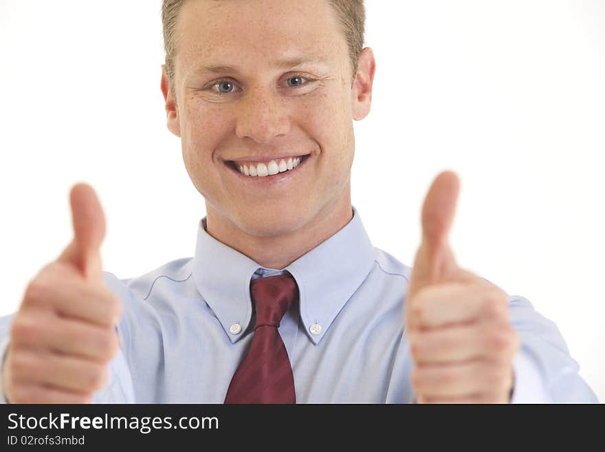 Portrait of smiling young businessman with two thumbs up